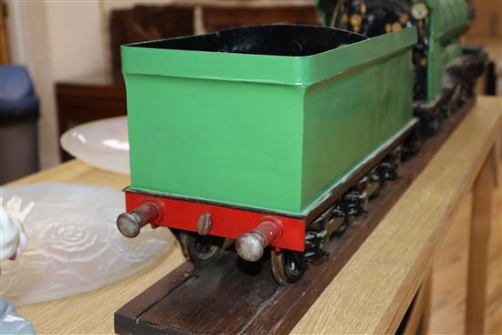 A 3.5 inch gauge 4-4-2 live steam locomotive and tender on wood stand, loco 27in. tender 18in.